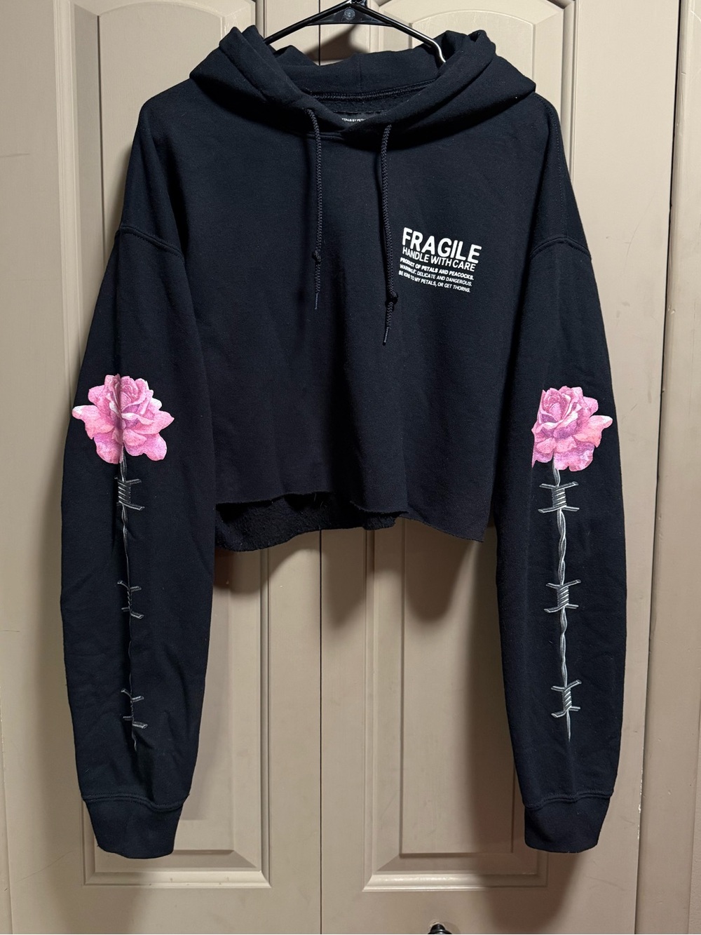 Fragile Black Cropped Hoodie with Pink Rose Sleeve Detail